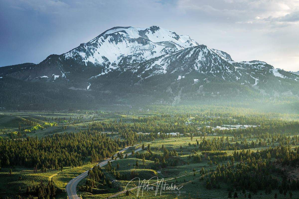 Snow-capped Mammoth Mountain rising above the valley and forest near Mammoth Lakes, California